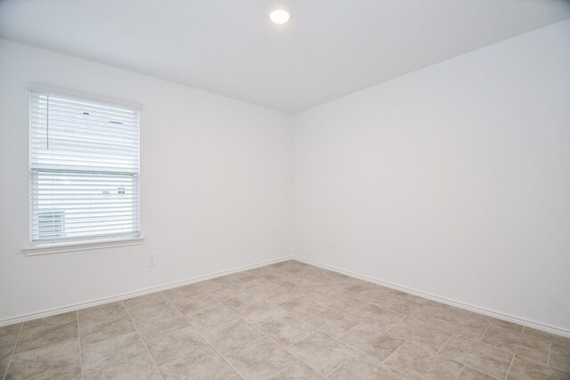 spare room with baseboards