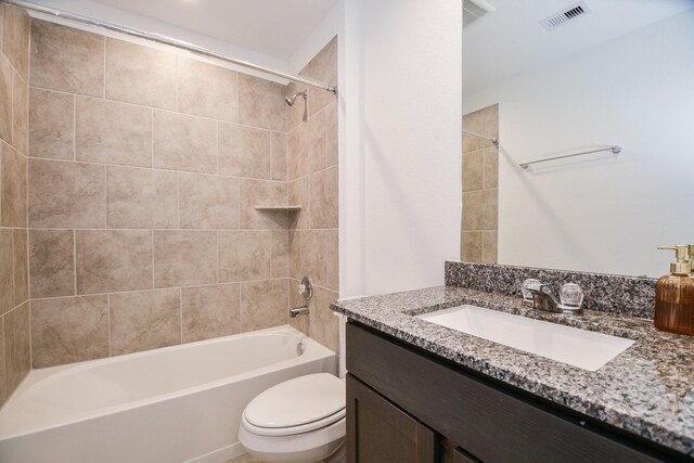 full bathroom featuring toilet, washtub / shower combination, and vanity