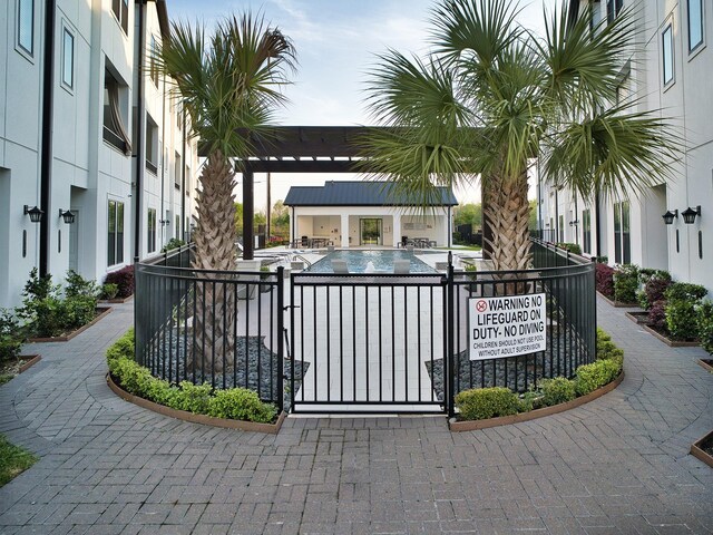 community pool featuring a patio and fence