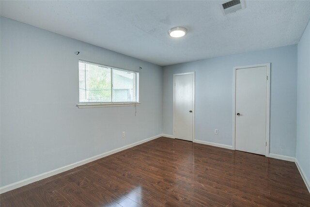 unfurnished room featuring wood finished floors and baseboards