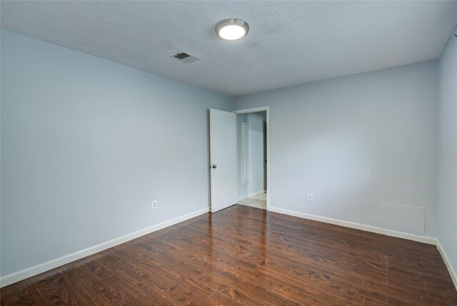 unfurnished room featuring baseboards and wood finished floors