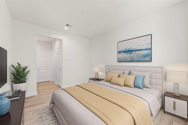 bedroom with light wood finished floors, recessed lighting, and baseboards