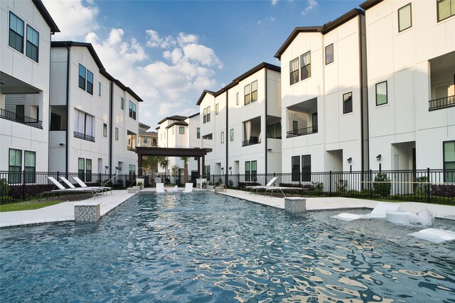 community pool with a residential view and fence