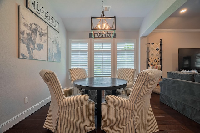 dining area featuring a chandelier, wood finished floors, and baseboards