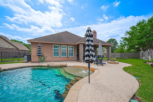 view of pool with an outdoor fire pit and a patio