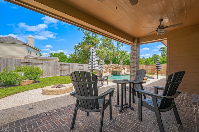 view of patio / terrace featuring a fire pit, ceiling fan, and a fenced backyard