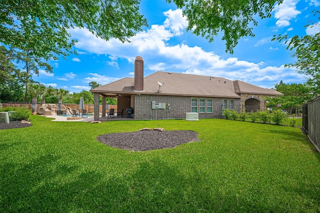 back of property featuring a chimney, a patio, ceiling fan, and roof with shingles