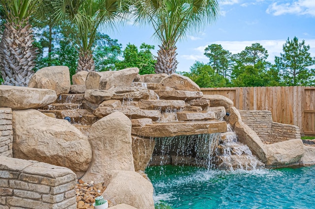 view of pool featuring fence