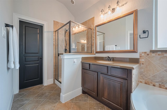 full bath with a shower stall, vanity, a bath, and vaulted ceiling