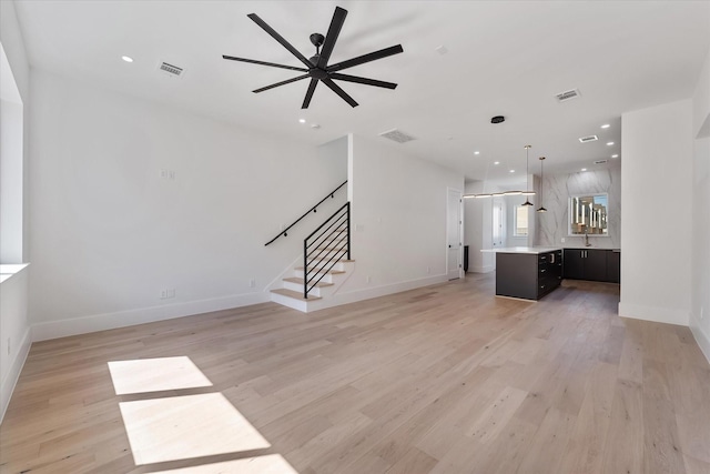 3912 Tulane St, Houston, TX 77018 - unfurnished living room featuring stairway, a ceiling fan, light wood finished floors, baseboards, and recessed lighting