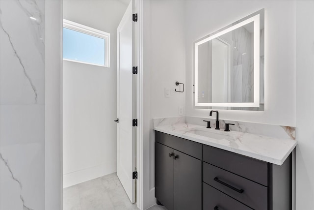 3912 Tulane St, Houston, TX 77018 - bathroom with vanity, marble look tiles, and baseboards