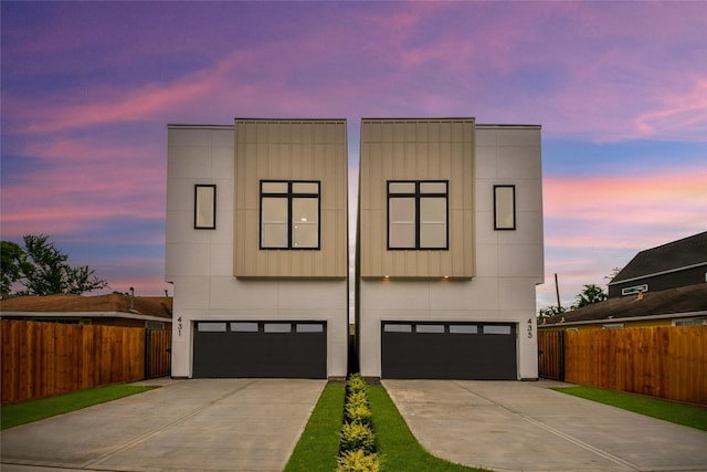 435 Neyland St, Houston, TX 77022 - modern home featuring an attached garage, concrete driveway, and board and batten siding