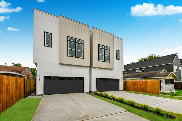 435 Neyland St, Houston, TX 77022 - contemporary house with an attached garage, driveway, and board and batten siding
