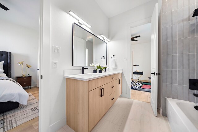 431 Neyland St, Houston, TX 77022 - ensuite bathroom featuring double vanity and baseboards