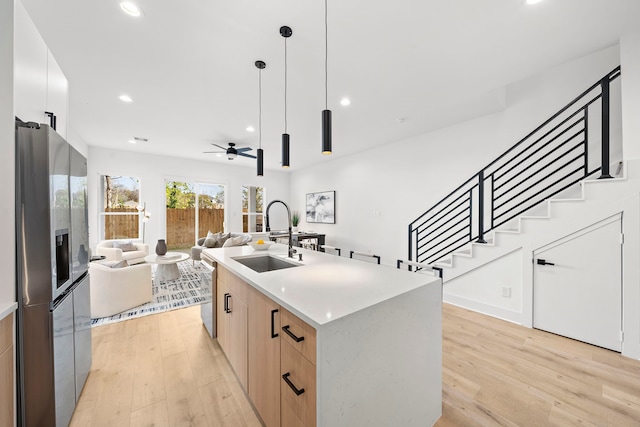 431 Neyland St, Houston, TX 77022 - kitchen with stainless steel appliances, a sink, modern cabinets, light wood-style flooring, and recessed lighting