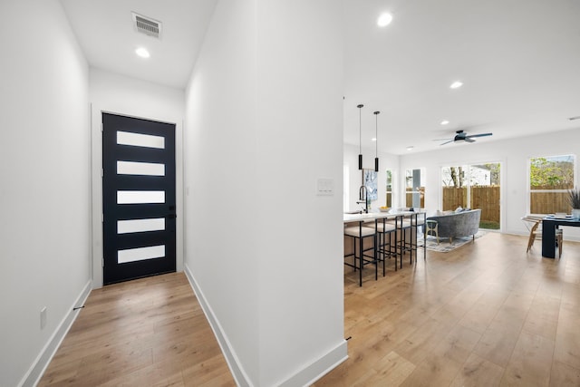 431 Neyland St, Houston, TX 77022 - foyer featuring light wood-style floors, recessed lighting, ceiling fan, and baseboards