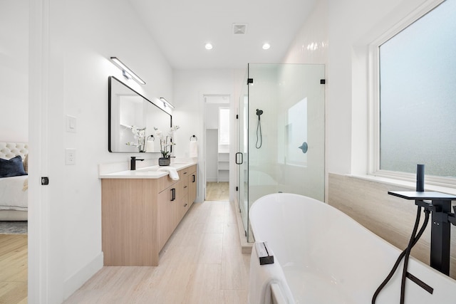 431 Neyland St, Houston, TX 77022 - full bath with ensuite bath, a stall shower, a freestanding tub, vanity, and recessed lighting