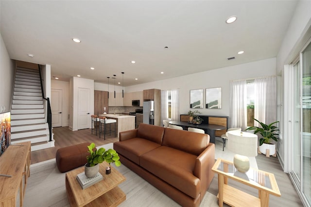 431 Neyland St, Houston, TX 77022 - living area with light wood finished floors, recessed lighting, and stairway