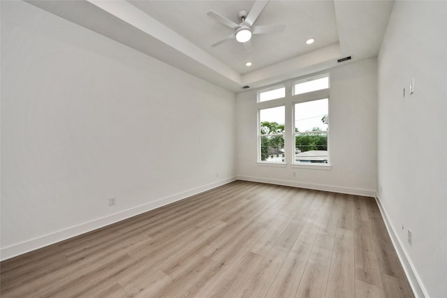 431 Neyland St, Houston, TX 77022 - empty room featuring wood finished floors, recessed lighting, a ceiling fan, and a tray ceiling