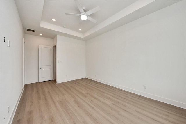 431 Neyland St, Houston, TX 77022 - unfurnished room with recessed lighting, light wood-style floors, a tray ceiling, and a ceiling fan