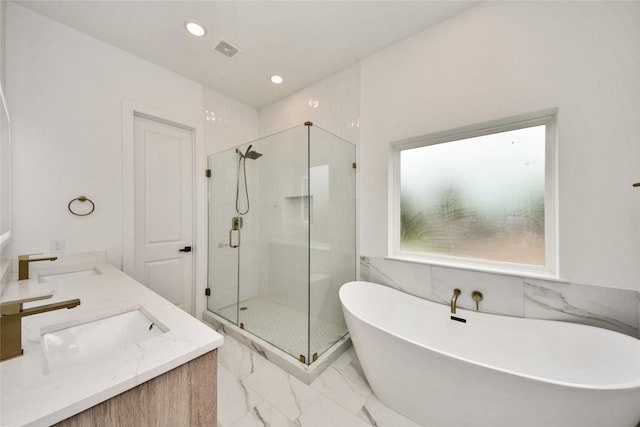 431 Neyland St, Houston, TX 77022 - full bathroom with a freestanding bath, a stall shower, marble finish floors, double vanity, and recessed lighting