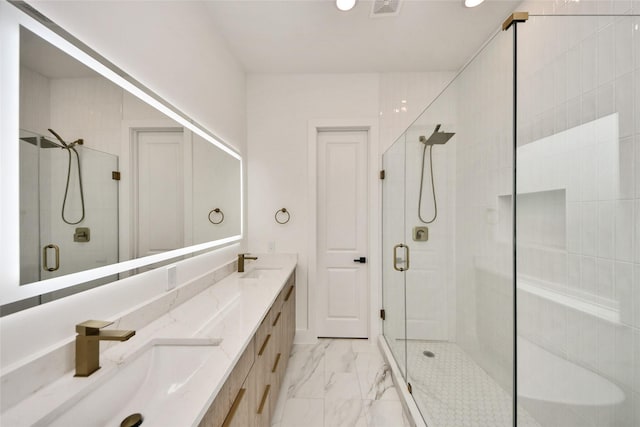 431 Neyland St, Houston, TX 77022 - bathroom featuring a shower stall, marble look tiles, double vanity, and recessed lighting