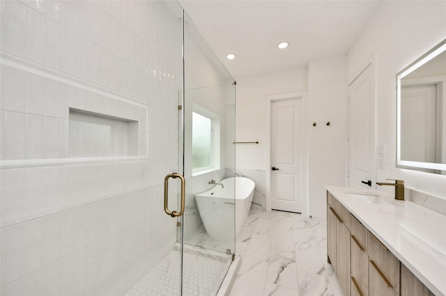 431 Neyland St, Houston, TX 77022 - bathroom with a freestanding bath, vanity, a shower stall, marble finish flooring, and recessed lighting