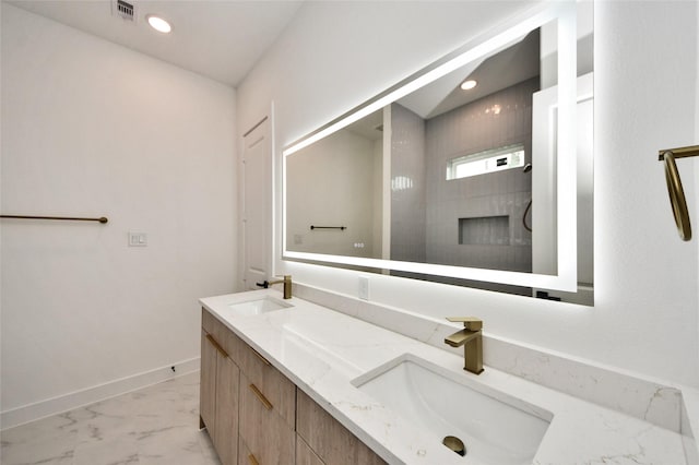431 Neyland St, Houston, TX 77022 - bathroom with marble look tile flooring, double vanity, and recessed lighting