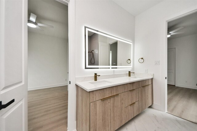 431 Neyland St, Houston, TX 77022 - bathroom with ceiling fan, double vanity, and wood finished floors
