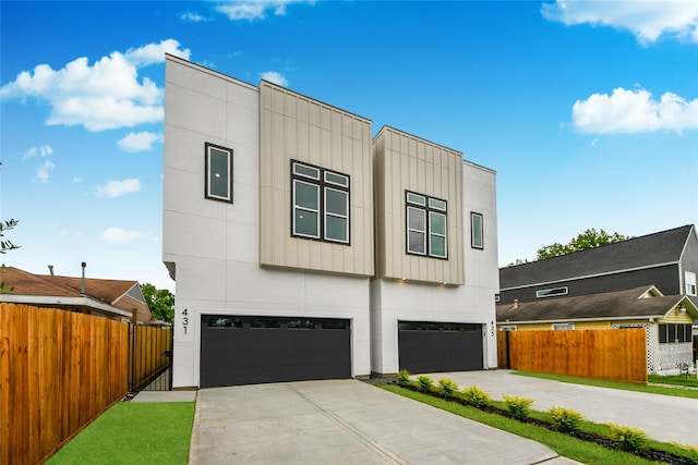 431 Neyland St, Houston, TX 77022 - modern home featuring a garage, driveway, and board and batten siding