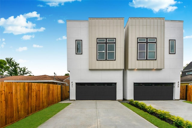431 Neyland St, Houston, TX 77022 - contemporary house featuring a garage, stucco siding, and concrete driveway