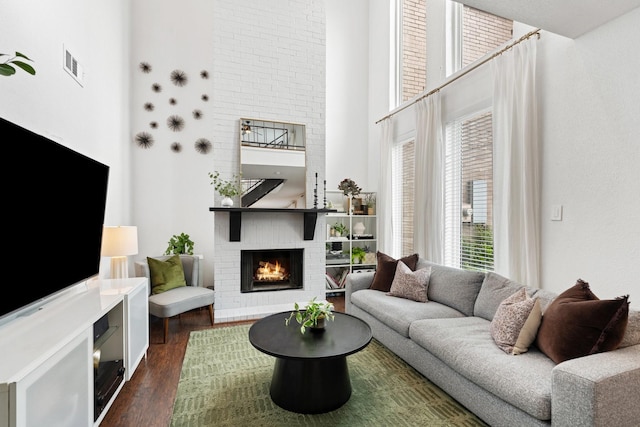 1115 Augusta Dr Unit 8, Houston, TX 77057 - living area featuring a brick fireplace, a high ceiling, and dark wood-style floors