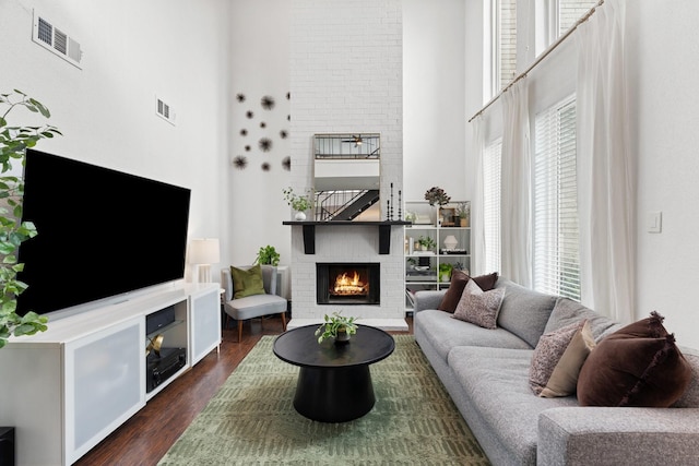 1115 Augusta Dr Unit 8, Houston, TX 77057 - living area with a towering ceiling, a large fireplace, and dark wood-style flooring