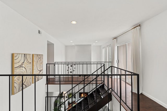 1115 Augusta Dr Unit 8, Houston, TX 77057 - hall featuring an upstairs landing, baseboards, wood finished floors, and recessed lighting