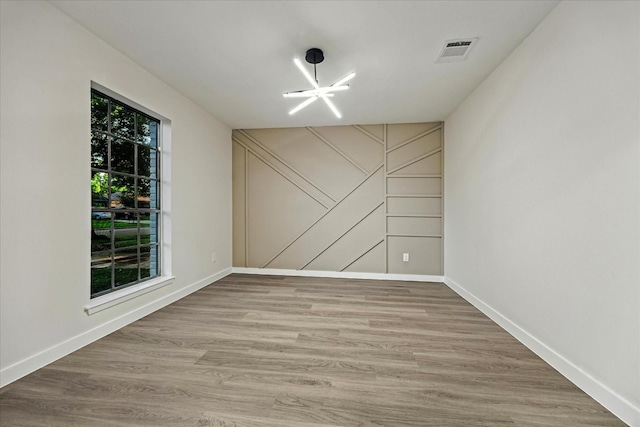 8902 Hendon Ln, Houston, TX 77036 - spare room with baseboards, a chandelier, and light wood-type flooring