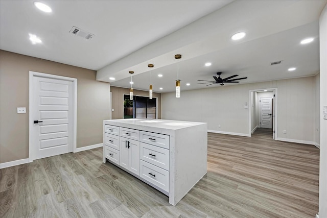 8902 Hendon Ln, Houston, TX 77036 - kitchen with ceiling fan, white cabinetry, light wood-type flooring, baseboards, and recessed lighting