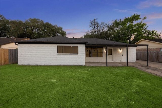 8902 Hendon Ln, Houston, TX 77036 - view of front of property with a patio area, brick siding, a carport, and roof with shingles
