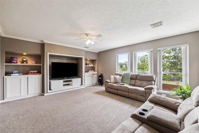 1703 Lakewinds Dr, Missouri City, TX 77459 - living room with a ceiling fan, a textured ceiling, built in shelves, carpet, and crown molding