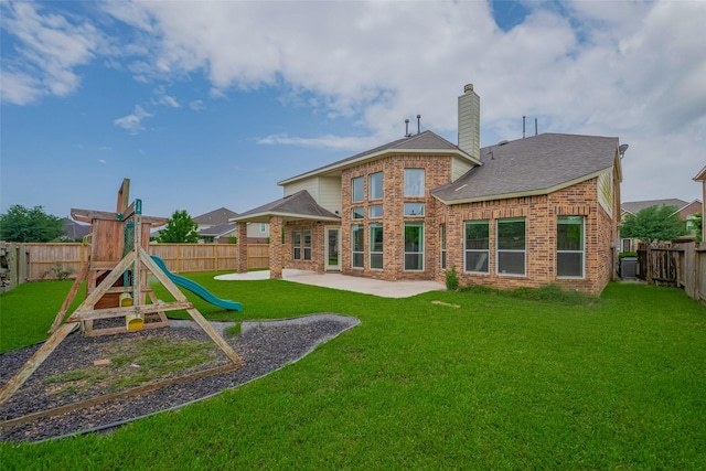 rear view of property with a patio area, a playground, brick siding, a chimney, and a shingled roof