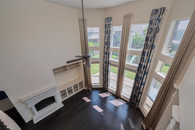 9968 Tallow Pointe Ln, Brookshire, TX 77423 - unfurnished living room with dark wood-type flooring, a fireplace, and ceiling fan