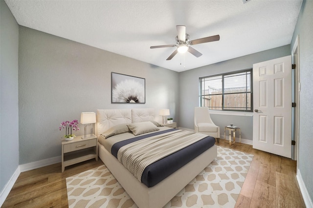 3726 Straightfork Dr, Houston, TX 77082 - bedroom with light wood-style flooring, baseboards, a textured ceiling, and ceiling fan