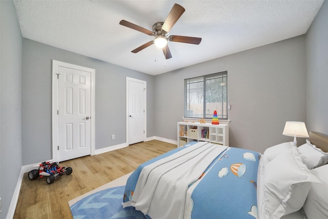 3726 Straightfork Dr, Houston, TX 77082 - bedroom featuring wood finished floors, baseboards, a ceiling fan, and a textured ceiling