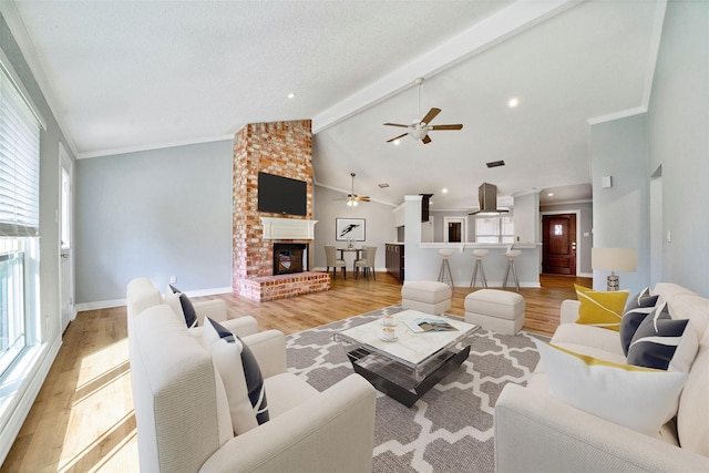 3726 Straightfork Dr, Houston, TX 77082 - living room with a ceiling fan, light wood finished floors, a fireplace, baseboards, and crown molding