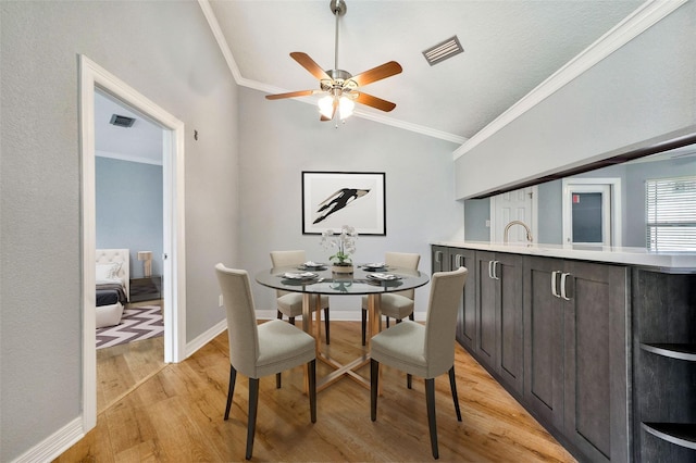 3726 Straightfork Dr, Houston, TX 77082 - dining area with light wood-style flooring, vaulted ceiling, ceiling fan, crown molding, and baseboards