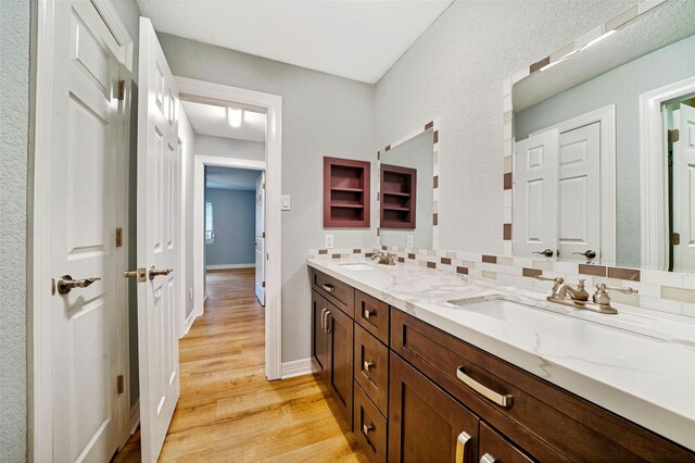3726 Straightfork Dr, Houston, TX 77082 - full bath featuring wood finished floors, double vanity, and baseboards