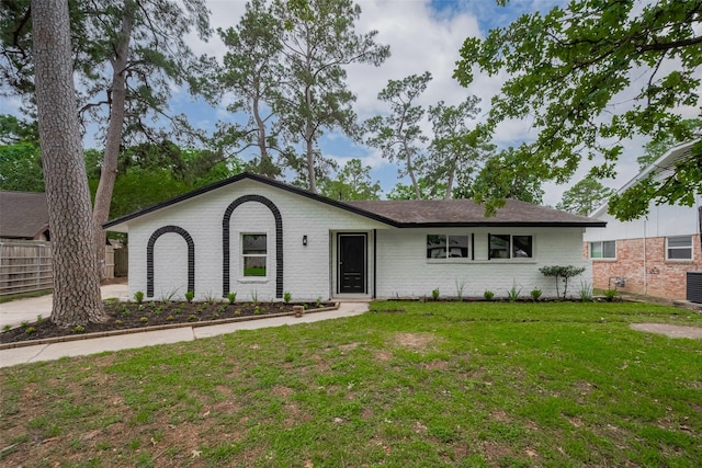 ranch-style home featuring brick siding and central AC unit