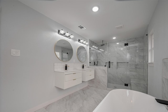full bath featuring a stall shower, marble look tile flooring, vanity, a freestanding bath, and recessed lighting