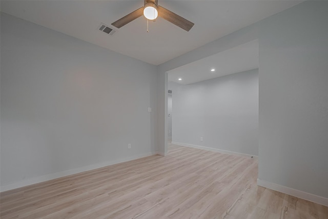 spare room featuring light wood-style flooring, recessed lighting, ceiling fan, and baseboards