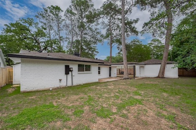 back of house featuring a patio and brick siding