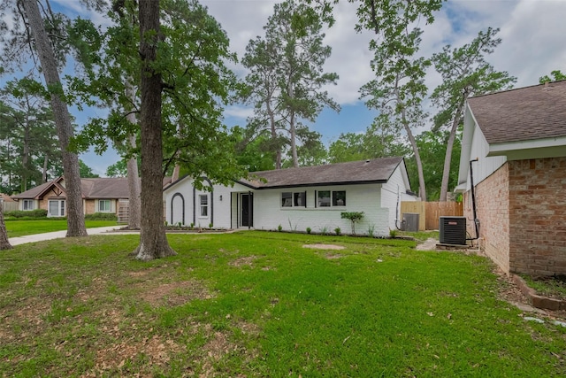 rear view of property featuring cooling unit and brick siding